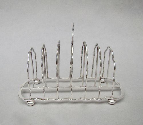 fig 1. GOOD EDWARDIAN SOLID SILVER TOAST RACK BY S. GARRARD, LONDON 1905