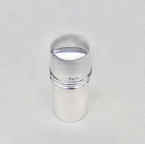 fig 1. A disassembled 1913 sterling silver sewing compendium showing the cylindrical case, tiered thread spool holder, cap lid, and textured thimble.