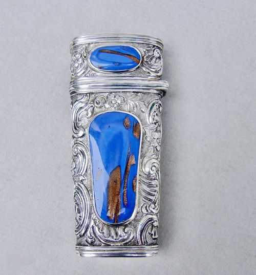 fig 1. An 18th-century French silver travelling etui featuring ornate repousse scrollwork and inlaid blue aventurine panels.