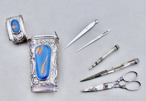 fig 3. An 18th-century French silver travelling etui featuring ornate repousse scrollwork and inlaid blue aventurine panels.