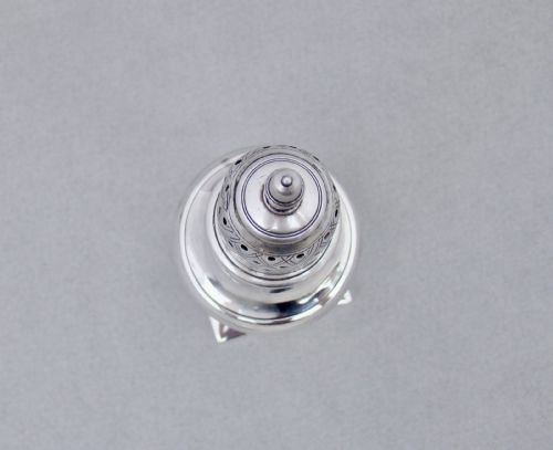 fig 2. A Georgian sterling silver sugar caster featuring a baluster-shaped body, square base, and a pierced lattice lid topped with a finial.