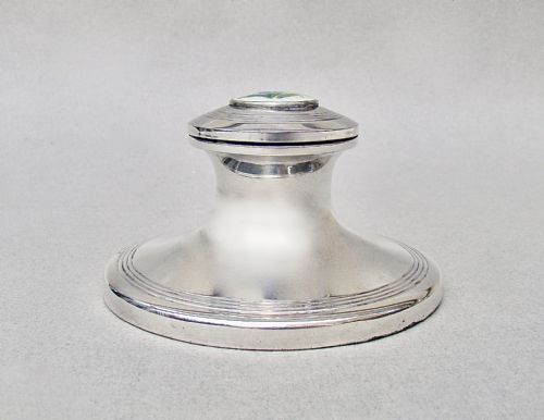 fig 2. A circular Edwardian sterling silver capstan inkwell featuring a hinged lid inset with a floral guilloche enamel medallion.