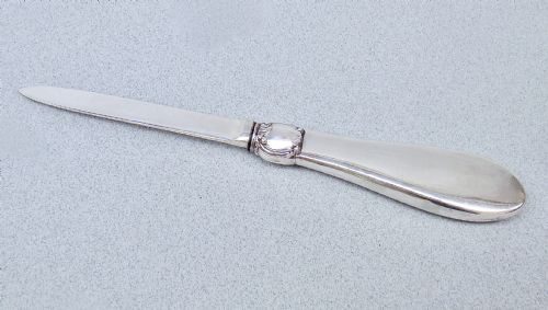 fig 2. An Art Deco sterling silver letter opener featuring a green shagreen inlay on the handle and British silver hallmarks on the blade.