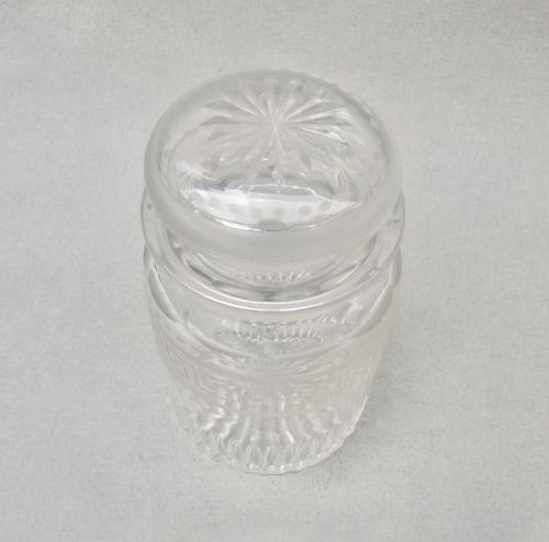 fig 1. A small clear Victorian glass pickle jar with a fitted lid, decorated with an etched Greek key motif and cut glass base.