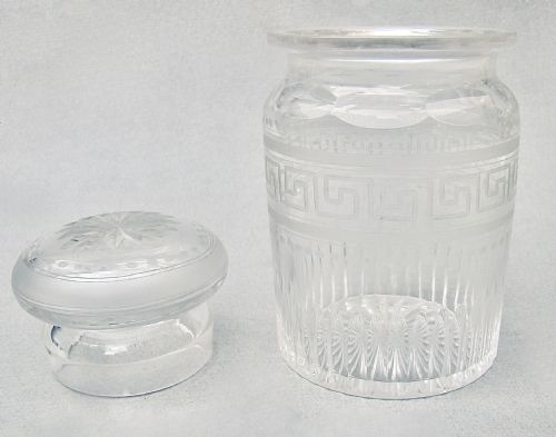 fig 2. A small clear Victorian glass pickle jar with a fitted lid, decorated with an etched Greek key motif and cut glass base.