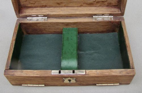 fig 4. An Edwardian oak box featuring sterling silver ribbon corner mounts and a silver script word reading Bridge on the lid.
