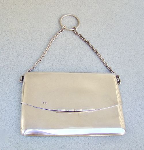 fig 2. An Edwardian sterling silver card case designed in the shape of an envelope with a suspension chain, resting inside a velvet-lined fitted box.