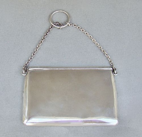 fig 3. An Edwardian sterling silver card case designed in the shape of an envelope with a suspension chain, resting inside a velvet-lined fitted box.