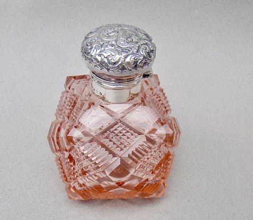 fig 2. A Victorian pale salmon pink cut glass scent bottle featuring a hand-chased sterling silver top.