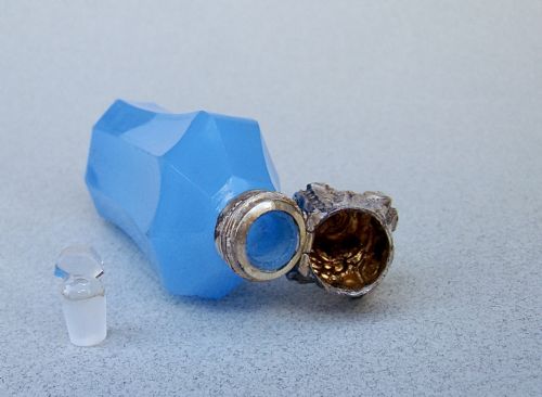 fig 3. A faceted turquoise blue opaline glass scent bottle featuring an embossed silver neck and cap.