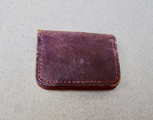 fig 2. A miniature dark brown leather sovereign purse featuring a silver-plated hinged metal catch.
