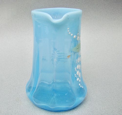 fig 2. A light blue opalescent glass cream jug featuring hand-painted enamel flora and dragonfly motifs with an applied clear glass handle.