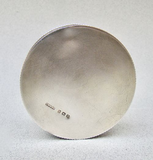fig 3. A circular Edwardian sterling silver trinket box with a white sunburst guilloche enamel lid decorated with hand-painted purple harebell flowers.