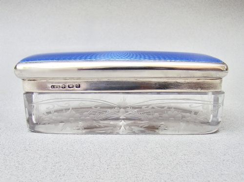 fig 1. An Art Deco rectangular cut glass dressing table jar with a sterling silver lid featuring vibrant blue guilloche enamel.