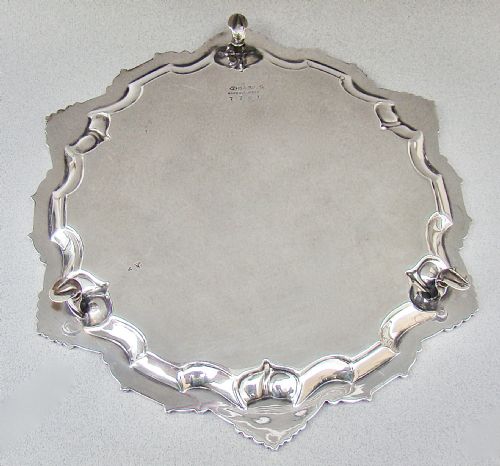 fig 2. A circular late Victorian silver-plated salver featuring a moulded, scalloped rim decorated with shell motifs.