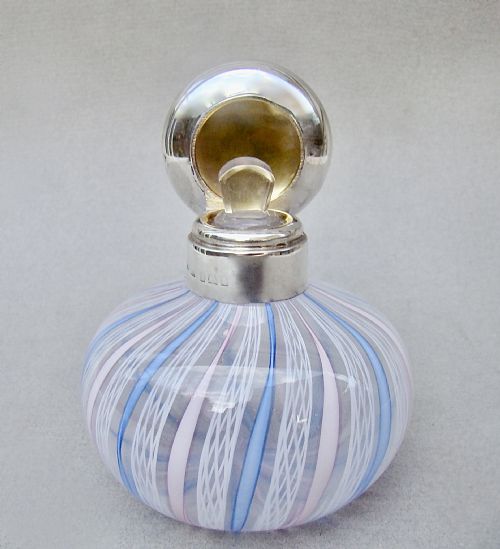 fig 2. An Edwardian squat glass scent bottle featuring blue, white, and pink latticino stripes topped with a polished silver cap.