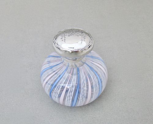 fig 3. An Edwardian squat glass scent bottle featuring blue, white, and pink latticino stripes topped with a polished silver cap.