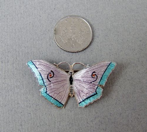 fig 2. An Art Deco sterling silver and guilloche enamel butterfly brooch featuring lilac and turquoise wings with delicate engine-turned patterns.