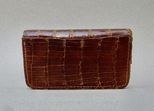 fig 1. An Edwardian dark brown crocodile skin purse with silver corner mounts and a silver push-button clasp.