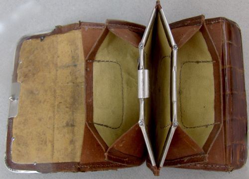 fig 2. An Edwardian dark brown crocodile skin purse with silver corner mounts and a silver push-button clasp.