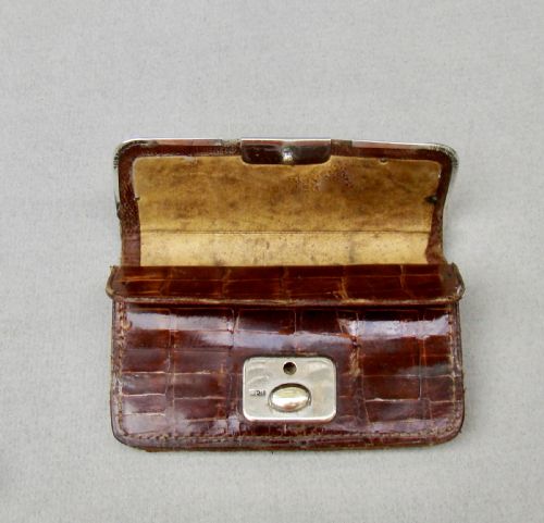 fig 3. An Edwardian dark brown crocodile skin purse with silver corner mounts and a silver push-button clasp.