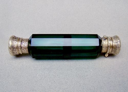 fig 1. A Victorian double-ended faceted Bristol green glass scent bottle featuring intricately engraved silver-gilt caps on both ends.