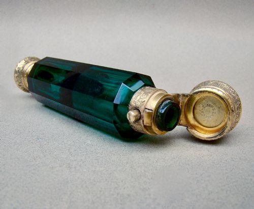 fig 2. A Victorian double-ended faceted Bristol green glass scent bottle featuring intricately engraved silver-gilt caps on both ends.