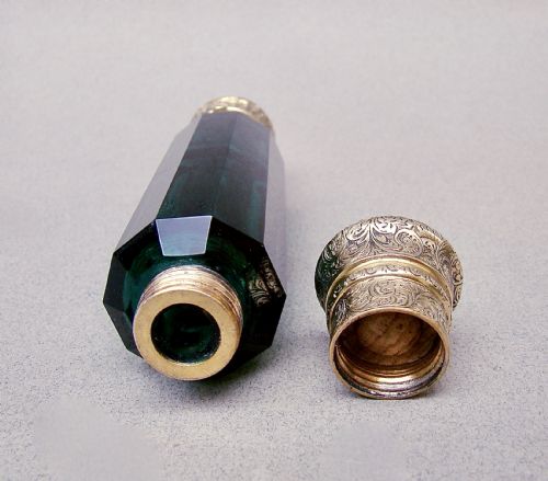 fig 3. A Victorian double-ended faceted Bristol green glass scent bottle featuring intricately engraved silver-gilt caps on both ends.