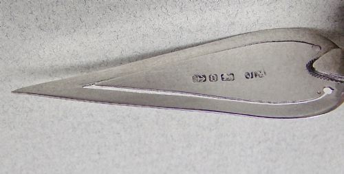 fig 2. A Victorian sterling silver trowel-shaped bookmark with an agate handle inside a red leather Harrods case.