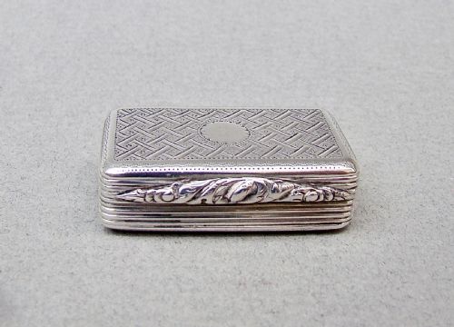 fig 1. A small rectangular Georgian sterling silver box featuring intricate lattice hand engraving, a central circular cartouche, and reeded sides.