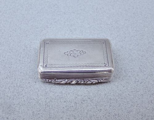 fig 2. A small rectangular Georgian sterling silver box featuring intricate lattice hand engraving, a central circular cartouche, and reeded sides.