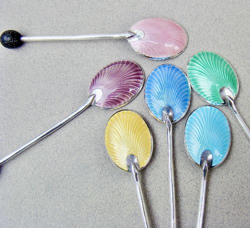 fig 2. A cased set of six sterling silver coffee spoons featuring bean knops and engine-turned guilloche enamel bowls in various pastel colours.