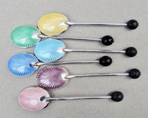 fig 3. A cased set of six sterling silver coffee spoons featuring bean knops and engine-turned guilloche enamel bowls in various pastel colours.