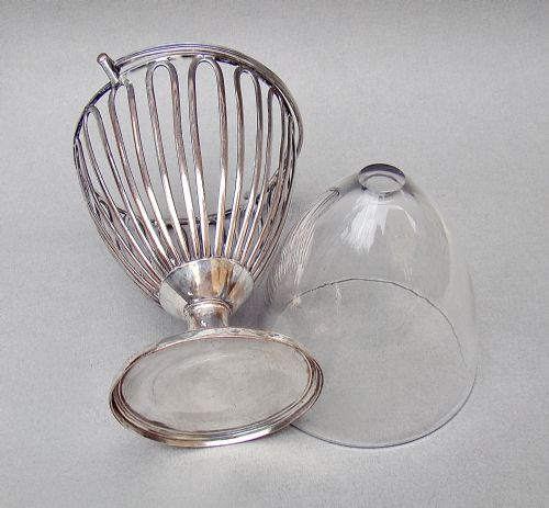 fig 3. A Georgian Old Sheffield Plate wirework sugar vase featuring an arched swing handle, loop-pattern wire body, and a turned pedestal base.