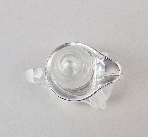 fig 3. An Art Deco clear glass oil bottle with a silver-mounted rim, stopper, and integral handle.