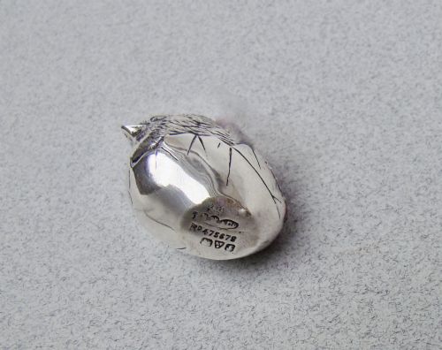 fig 3. An Edwardian sterling silver pin cushion formed as a hatching chick emerging from an eggshell with a red velvet insert.