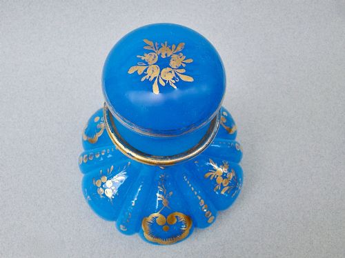 fig 1. A bright blue lobed opaline glass scent bottle with a flared rim, ground glass stopper, and hand-gilded floral motifs.