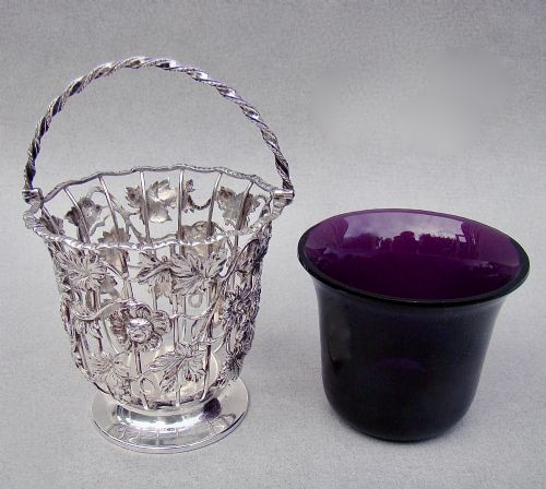fig 3. A sterling silver wirework sugar basket featuring a twisted swing handle, cast vine leaf motifs, and a removable purple glass liner.