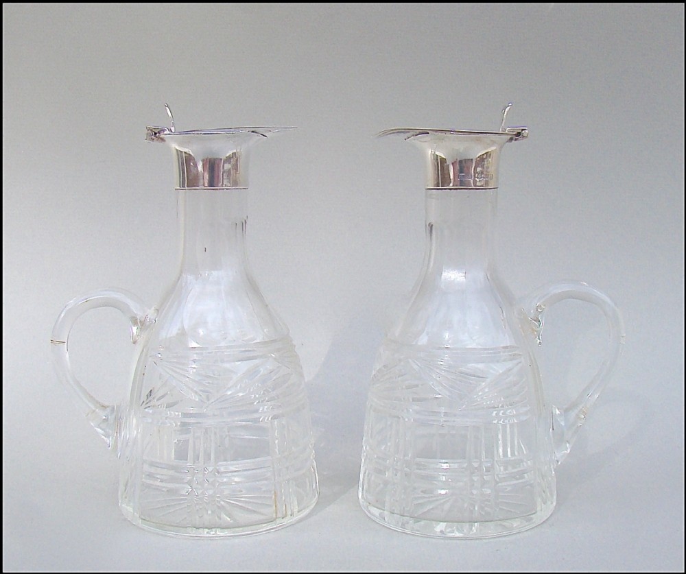 PAIR OF SILVER MOUNTED WHISKY TOTS BY LEVI & SALAMAN, BIRMINGHAM 1926
