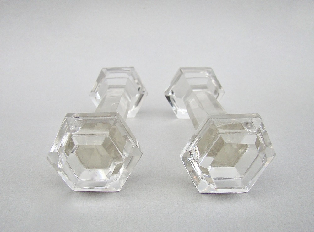 A pair of clear Victorian cut crystal glass knife rests featuring faceted octagonal ends and a central connecting bar. View III