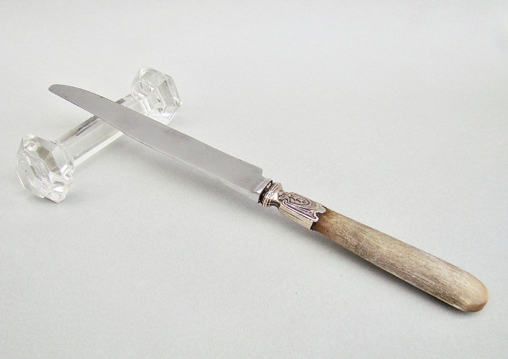 A pair of clear Victorian cut crystal glass knife rests featuring faceted octagonal ends and a central connecting bar. View V