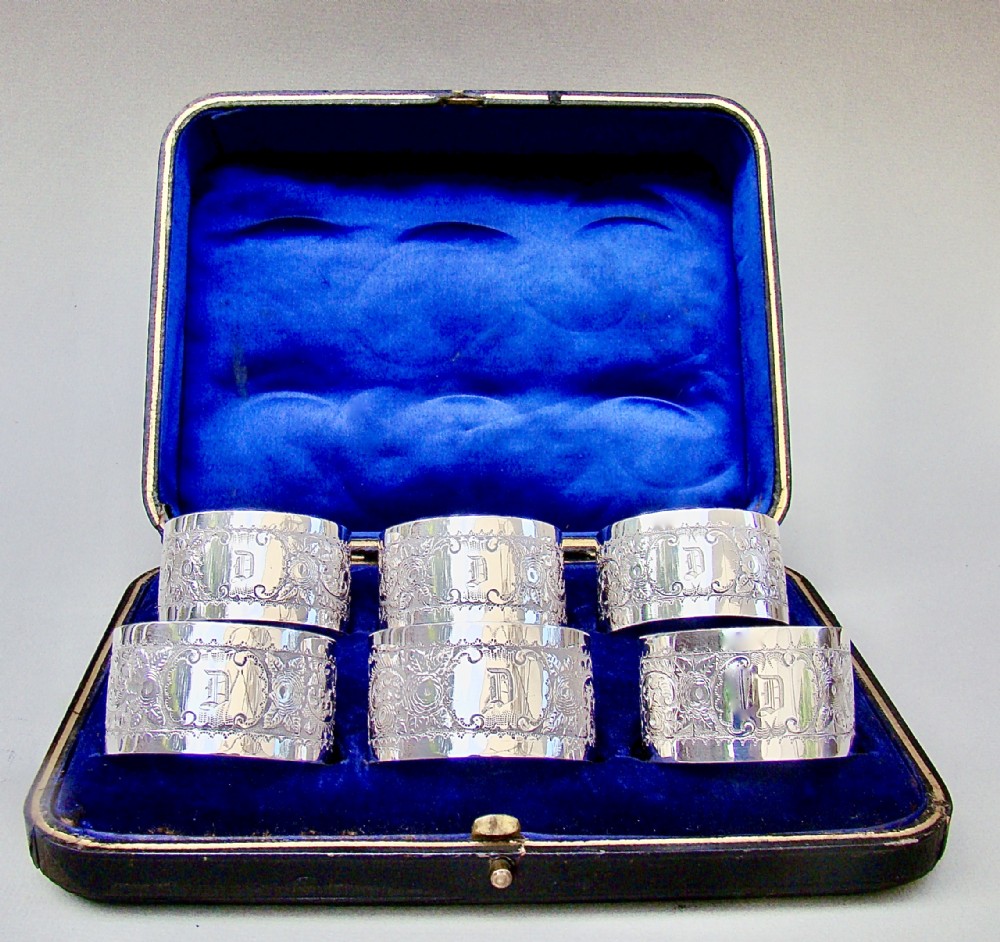 SET OF SIX VICTORIAN SILVER PLATED MONOGRAMMED NAPKIN RINGS, CIRCA 1890