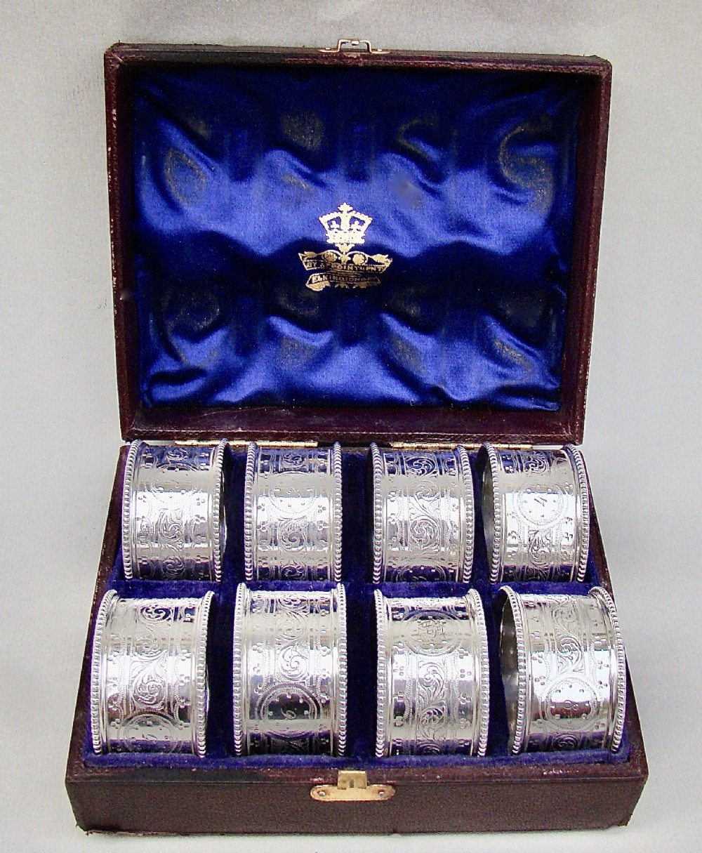 CASED SET OF EIGHT VICTORIAN SILVER PLATED NUMBERED NAPKIN RINGS, CIRCA 1880