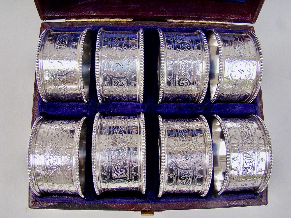 CASED SET OF EIGHT VICTORIAN SILVER PLATED NUMBERED NAPKIN RINGS, CIRCA 1880 View VII