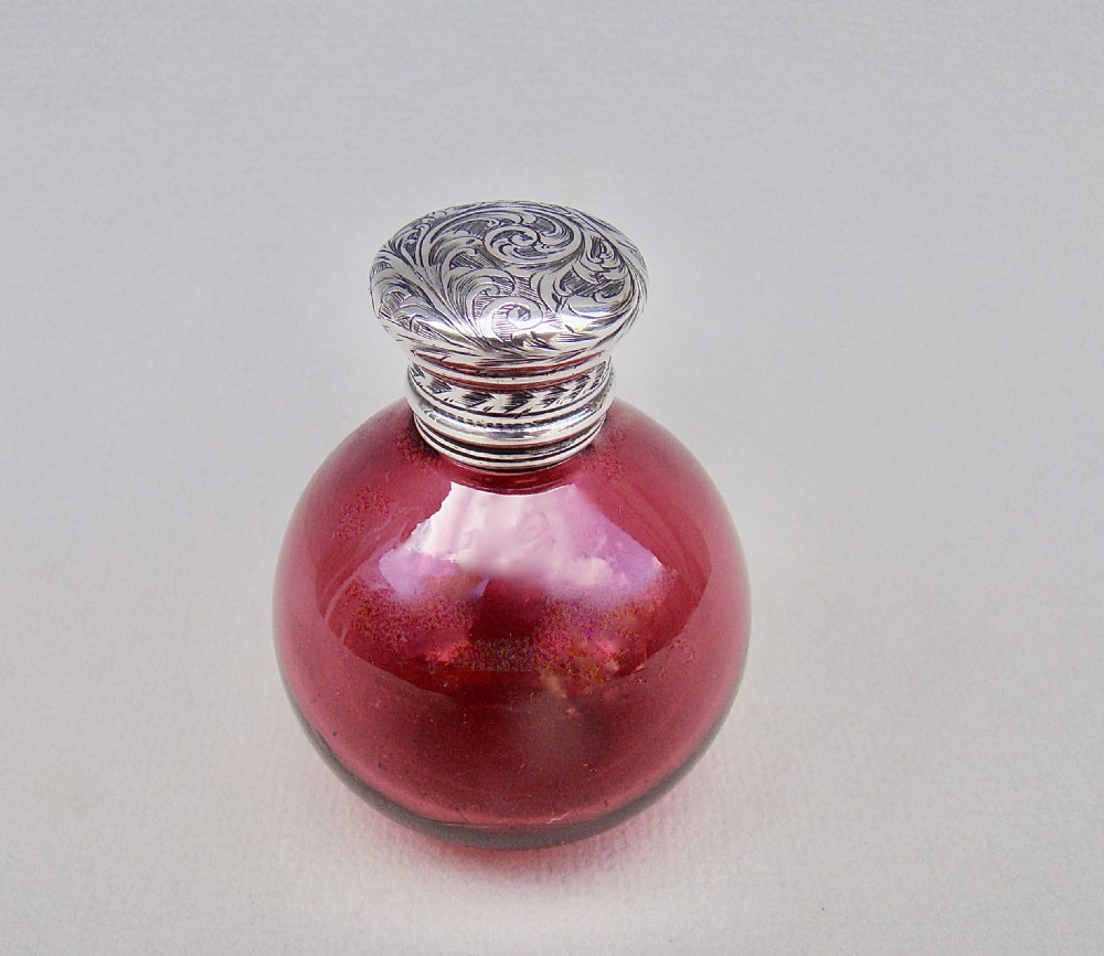 SMALL AND EXQUISITE VICTORIAN SILVER AND CRANBERRY GLASS SCENT BOTTLE, CIRCA 1890