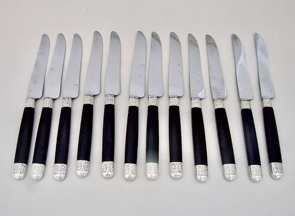 FABULOUS CASED SET OF TWELVE SILVER PLATED FRENCH SMALL KNIVES WITH EBONY HANDLES AND STEEL BLADES, PARIS CIRCA 1890