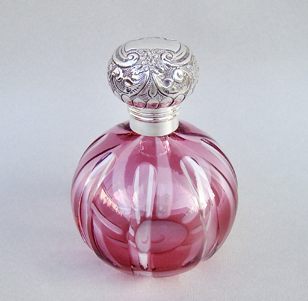 LARGE EDWARDIAN SILVER AND CRANBERRY GLASS SCENT BOTTLE BY WALKER & HALL, SHEFFIELD CIRCA 1900