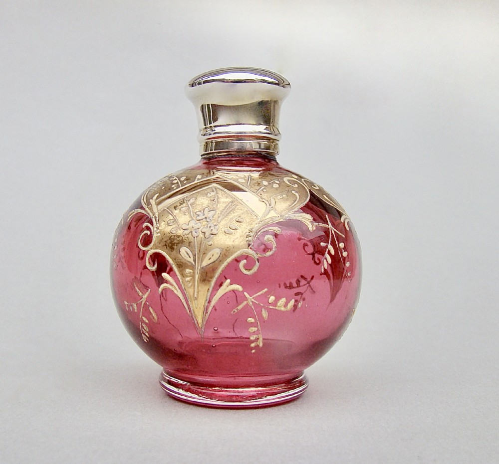 VICTORIAN SILVER GILT ENAMELLED CRANBERRY GLASS SCENT BOTTLE, CIRCA 1890