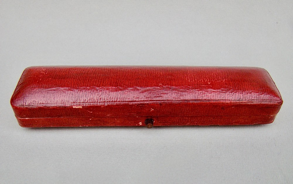 A cased set of six Art Nouveau pierced sterling silver buttons arranged inside a red velvet-lined fitted box. View VI