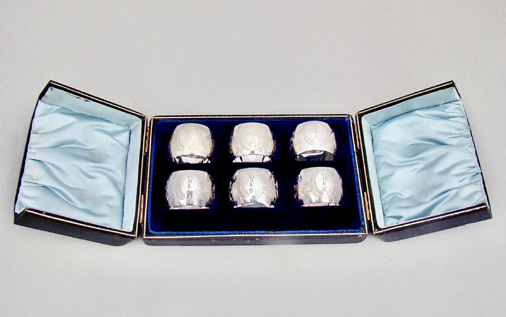 EXQUISITE CASED SET OF SIX VICTORIAN SILVER PLATED NUMBERED AND INITIALLED NAPKIN RINGS, CIRCA 1890 View II